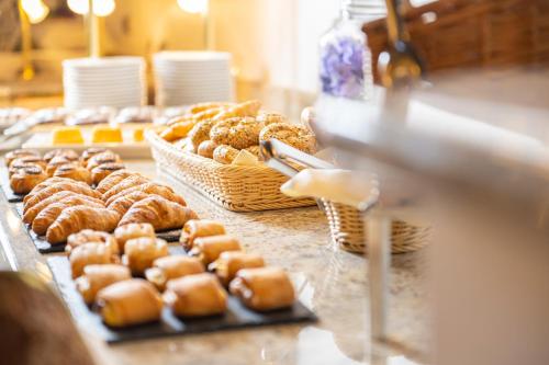 a bunch of donuts on a counter in a bakery at EUROPÄISCHER HOF Bad Gastein in Bad Gastein