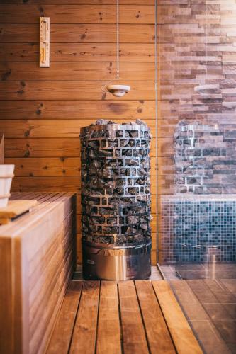 a stack of logs in a room with a stone wall at Bringa Villa in Balatonlelle