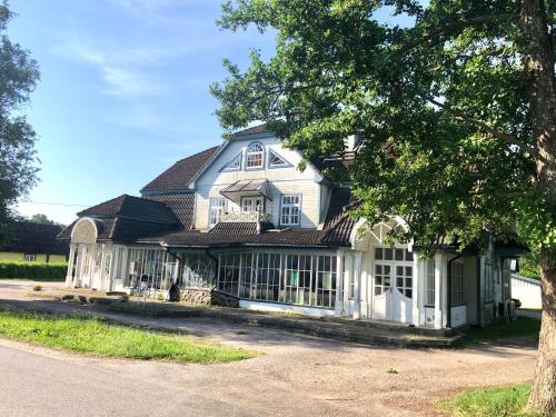 a large white house with a gambrel roof at Captain's House - Kaptenimaja - Apartments in Kärdla