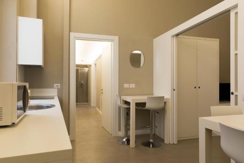 a kitchen with a white counter and a mirror at Palazzo dei Ciompi Suites in Florence