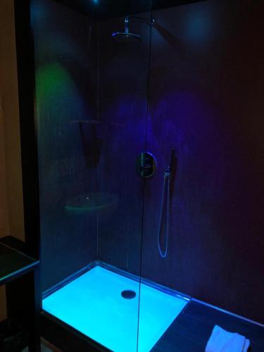 a shower with a glass door with a sink at Hotel Cimarosa in Naples