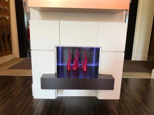 a display of red shoes on a black table at Hotel Cimarosa in Naples