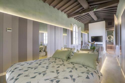a bedroom with a large bed with green pillows at Palazzo dei Ciompi Suites in Florence