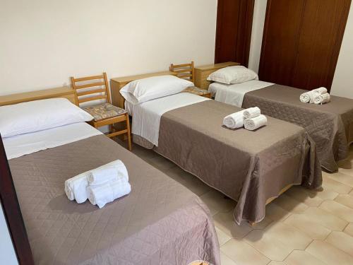 three beds in a room with towels on them at Casa Sisina in Conca dei Marini