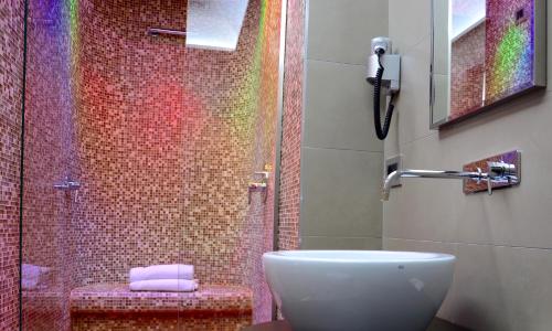 a bathroom with a sink and a shower with a rainbow at Hotel Cimarosa in Naples