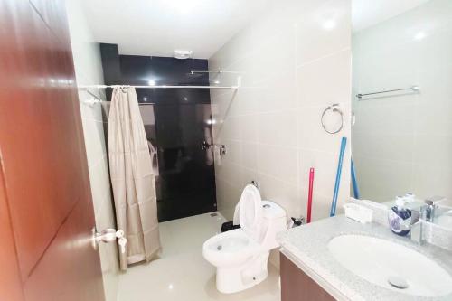 a bathroom with a toilet and a sink at Mi casa, su casa - Moderno y Chic. in Santa Cruz de la Sierra