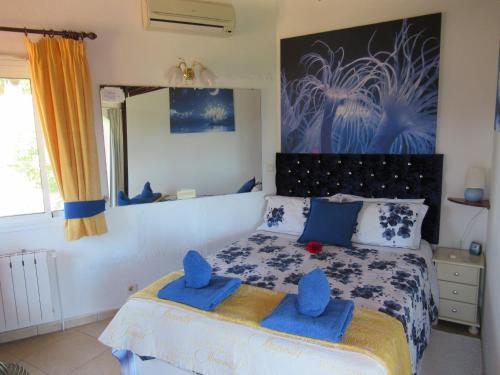 a bedroom with a bed with blue towels on it at Villa Mimosa in Moraira