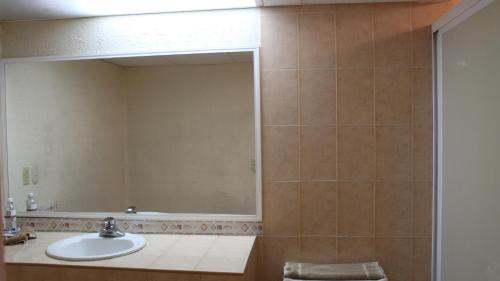 a bathroom with a sink and a mirror at Hotel La Villa in Torreón