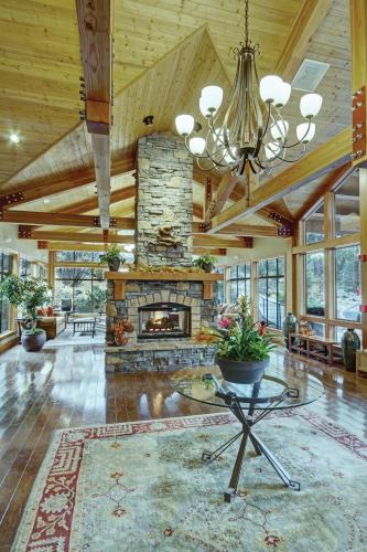 a living room with a stone fireplace and a chandelier at Seventh Mountain Resort in Bend