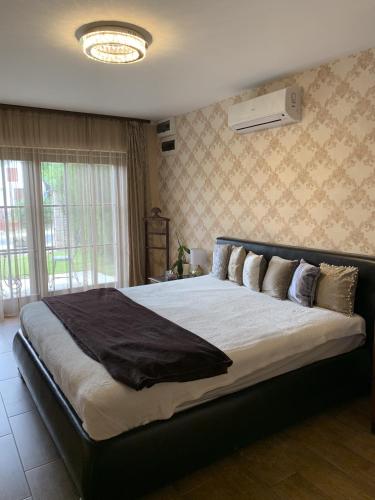 a bedroom with a large bed in a room at Villa Garden in Zalaegerszeg