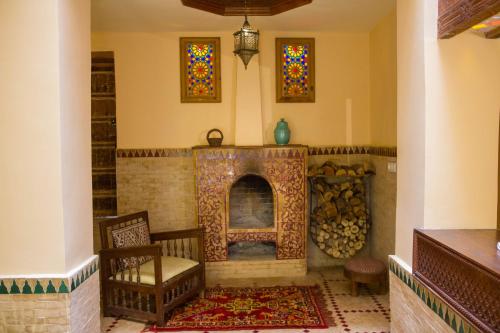 a living room with a fireplace and stained glass windows at Medina social club in Fès