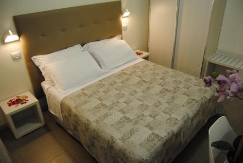 a bedroom with a large bed with a large headboard at Hotel Tenerife in Riccione