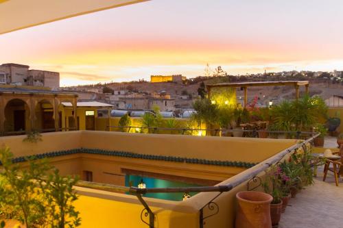 a balcony with a view of a city at sunset at Medina social club in Fez