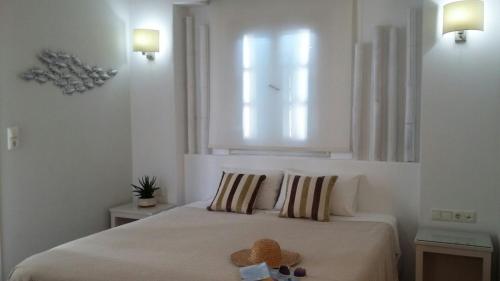 a bedroom with a bed with a teddy bear on it at Blue Sky Summer in Naxos Chora