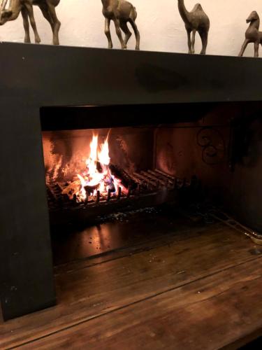 a fireplace with a fire inside of it at Pousada Boutique Itaipava in Itaipava