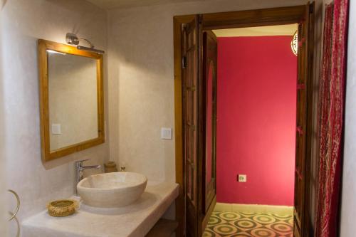a bathroom with a sink and a mirror at Medina social club in Fès