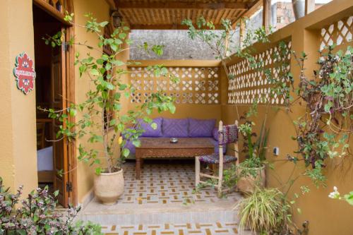 a patio with a blue couch in a courtyard at Medina social club in Fès