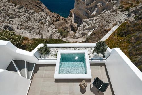 a swimming pool with a view of a mountain at Volcano View by Caldera Collection in Fira