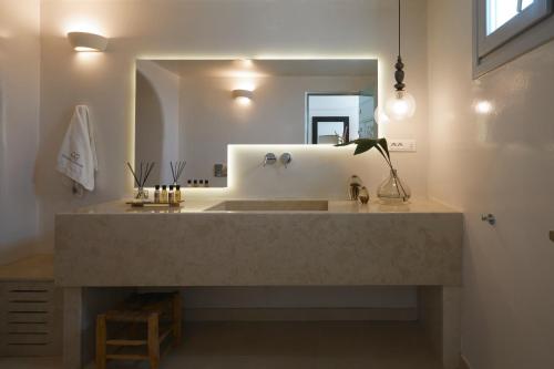 a bathroom with a large sink and a mirror at Volcano View by Caldera Collection in Fira