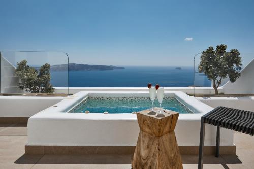 a bath tub in the middle of a patio with the ocean at Volcano View by Caldera Collection in Fira