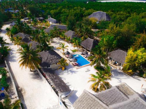 an aerial view of a resort with a pool and palm trees at Kikoi Boutique Hotel in Michamvi