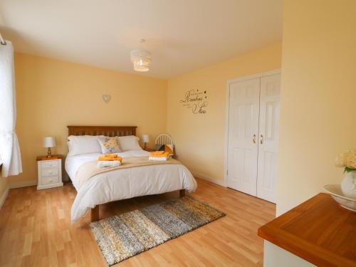 a bedroom with a bed and a rug at Slieve Gallion Cottage in Magherafelt