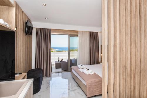 a hotel room with a bed and a view of the ocean at Xasteria in Elafonisi