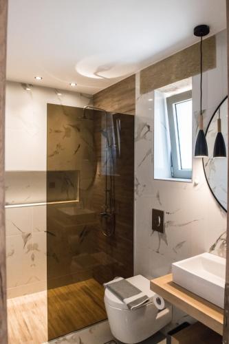 a bathroom with a toilet and a sink at Xasteria in Elafonisi