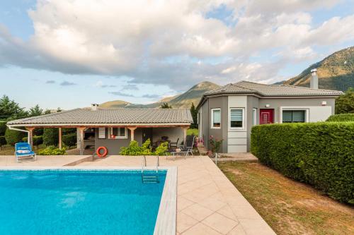 a house with a swimming pool in front of a house at Villa Stymfalia - Luxury Mansion with Private Pool in Kartérion