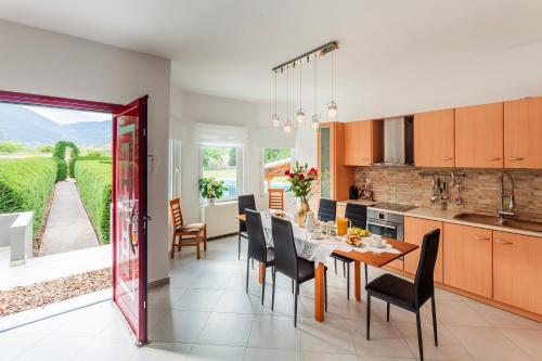 a kitchen and dining room with a table and chairs at Villa Stymfalia - Luxury Mansion with Private Pool in Kartérion