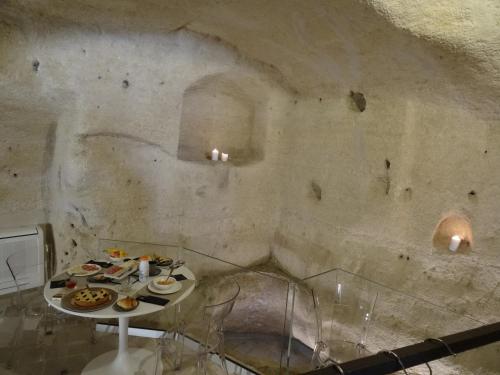 a room with a table with food on it at LA DIMORA DELLE 3 ZIE in Matera