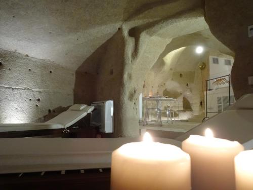 a room with two candles and a room with a tub at LA DIMORA DELLE 3 ZIE in Matera