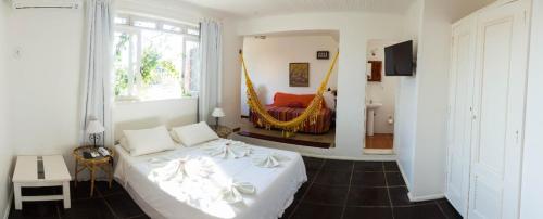 Cama o camas de una habitación en Pousada Hotel Praia dos Anjos