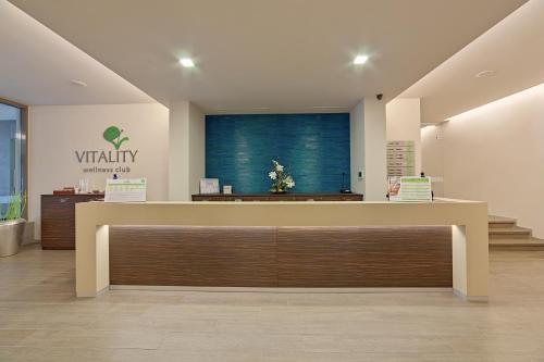 a view of a waiting room with a reception desk at Ramada Plaza by Wyndham Bucharest Convention Center in Bucharest