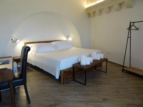 a bedroom with a bed and a table with candles at LA DIMORA DELLE 3 ZIE in Matera