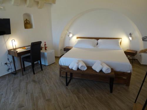 a bedroom with a bed with a desk and a chair at LA DIMORA DELLE 3 ZIE in Matera