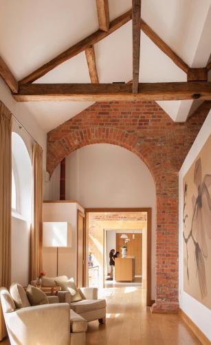 an archway in a living room with a brick wall at Four Seasons Hotel Hampshire in Winchfield