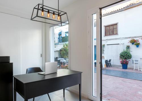 an office with a desk with a laptop on it at The Old Town Boutique Hotel - Adults Recommended in Estepona