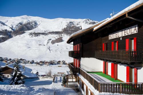 snow covered mountains in the background of a ski lodge at Hotel Teola in Livigno