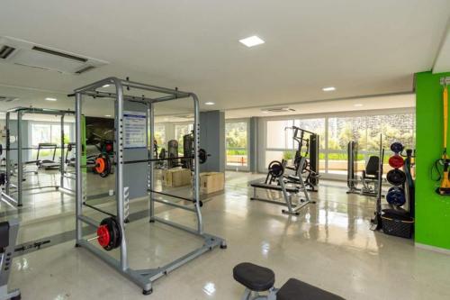 a gym with several tread machines in a room at Flat The Expression 1210 in Goiânia