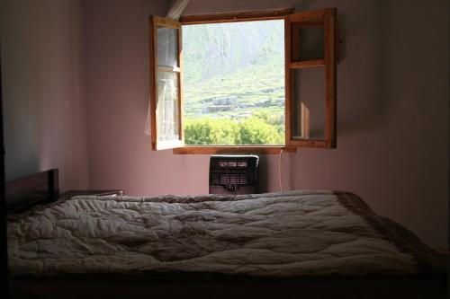 a bedroom with a bed and a window at Guest House Nazy in Stepantsminda