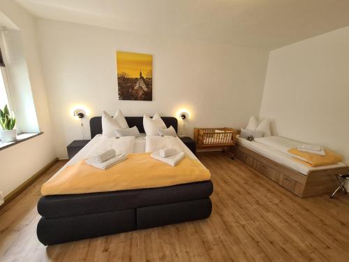 a bedroom with a large bed and a couch at Ferienwohnung 2 Christiansdorf Freiberg in Freiberg