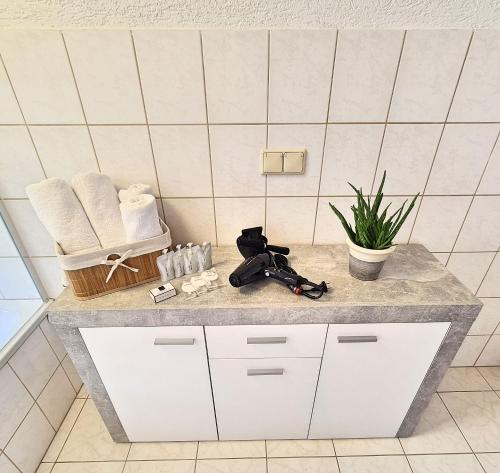 a bathroom counter with towels and a camera on it at Ferienwohnung 2 Christiansdorf Freiberg in Freiberg