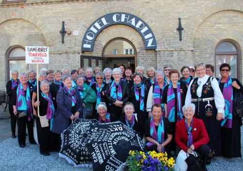 a group of older people posing for a picture in front of a building at Hotel Chaplin in Landskrona
