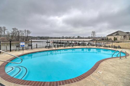 a large swimming pool with tables and chairs around it at Lake-View Balcony Hot Springs Penthouse! in Hot Springs
