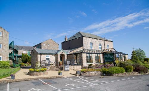 a building on the corner of a street at The Melbreak Hotel in Great Clifton