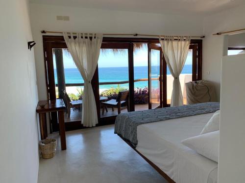 a bedroom with a bed and a view of the ocean at El Alquimista Yoga Spa in Zipolite