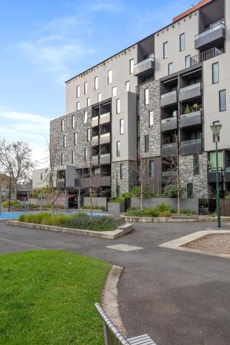 an empty parking lot in front of a building at Palmerston St Apartments by Urban Rest in Melbourne