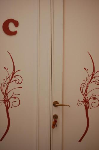 two doors with metal vines on them at Casa Giulia in Pisa