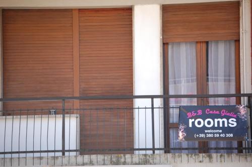 a sign on a fence in front of a building at Casa Giulia in Pisa